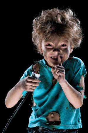 Portrait of funny little electrician over black backgroundの写真素材