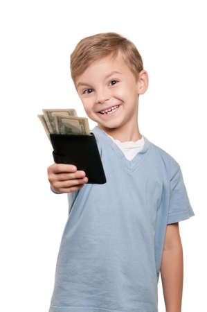 Portrait of a happy little boy with a dollars over white backgroundの写真素材