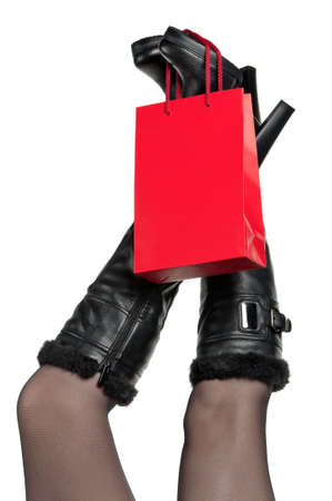 Detail of standing woman wearing fashionable black boots posing on whiteの写真素材