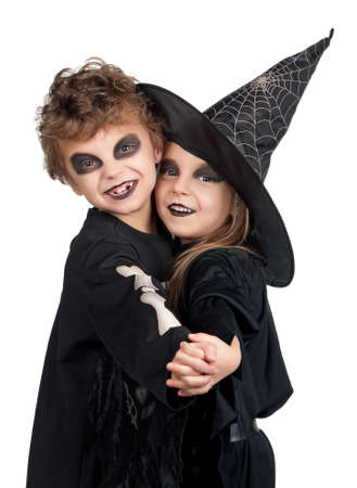 Boy and girl wearing halloween costume with pumpkin on white backgroundの写真素材