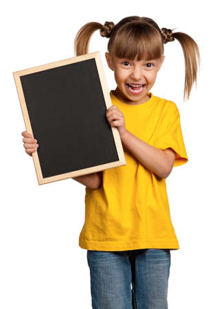 Portrait of little girl with blackboard isolated on white backgroundの写真素材