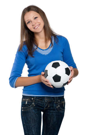 Beautiful teen girl with classic soccer ball posing on white backgroundの写真素材