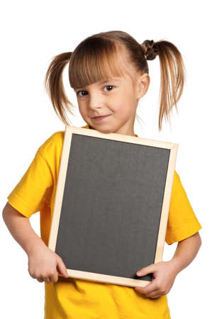 Portrait of little girl with blackboard isolated on white backgroundの写真素材