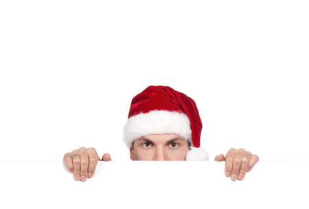 Portrait of handsome man in santa hat with blank billboard on white background