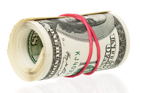 Roll of dollars with rubber band isolated on white background