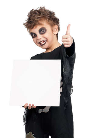 Portrait of little boy wearing halloween costume with empty white board on white backgroundの写真素材