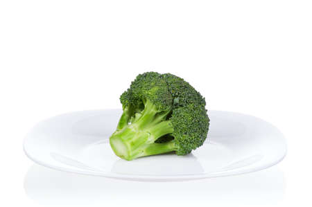 Fresh ripe broccoli piece on plate on white backgroundの写真素材