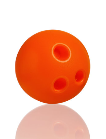 Single plastic orange ball of toy bowling isolated on a white backgroundの写真素材