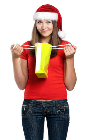 Beautiful teen girl in Santa hat posing on white backgroundの写真素材