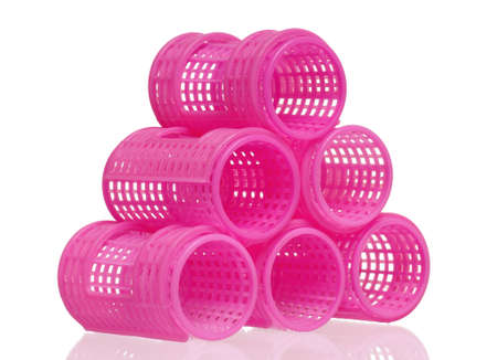 Stack of pink hair curlers isolated on white backgroundの写真素材