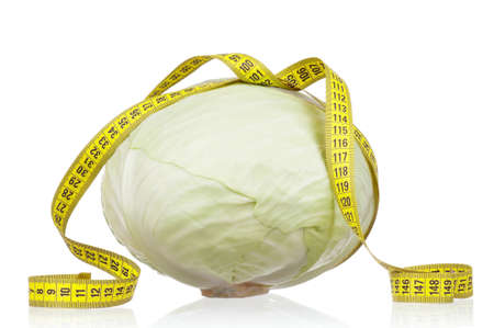 Fresh green cabbage vegetable with measure tape on white backgroundの写真素材