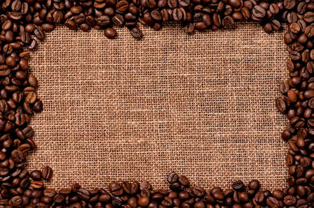 Frame made of coffee beans on the old burlapの写真素材