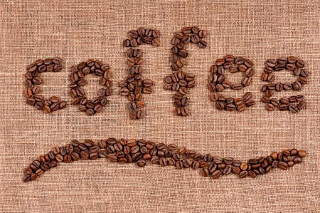 Word coffee made from coffee beans on burlapの写真素材
