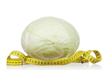 Fresh green cabbage vegetable with measure tape on white backgroundの写真素材