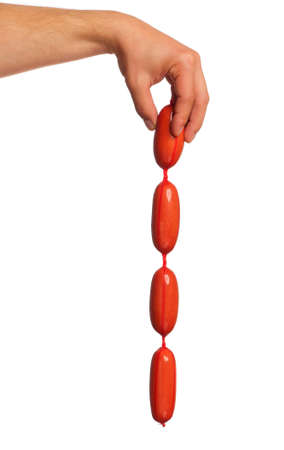 Man hand with sausage isolated on white backgroundの写真素材