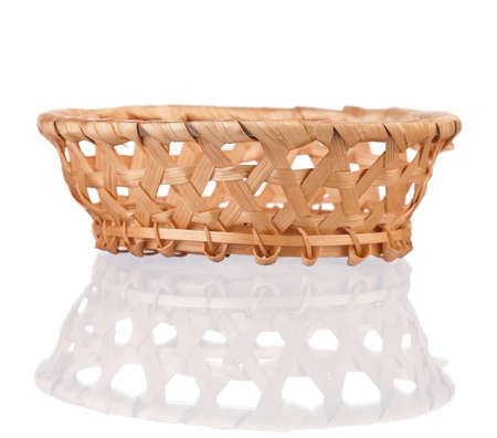 Empty small wicker basket isolated on white backgroundの写真素材