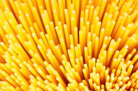 Close-up of long uncooked italian spaghetti backgroundの写真素材