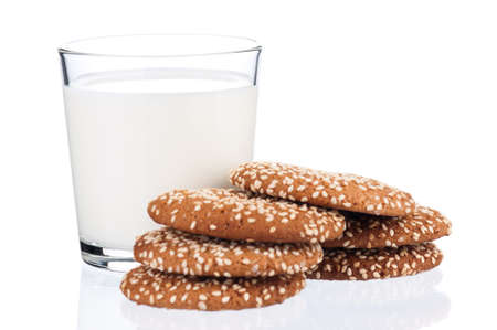 Glass of milk with cookies isolated on white backgroundの写真素材