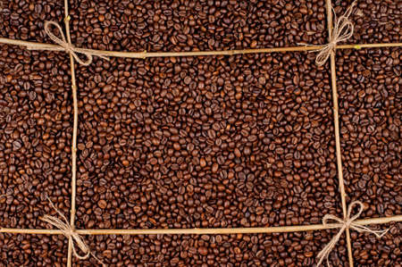 Frame made of coffee beans with tree branchesの写真素材