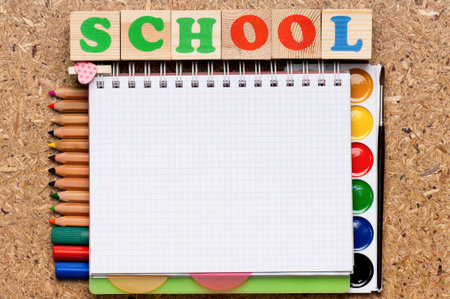 Frame from school accessories and wooden toy cubes with letters