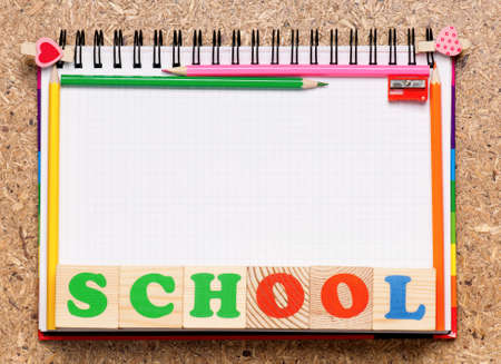 Frame from school accessories and wooden toy cubes with lettersの写真素材