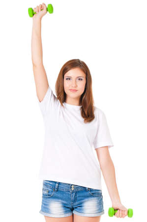 Teen girl with dumbbells working out, isolated on white backgroundの写真素材