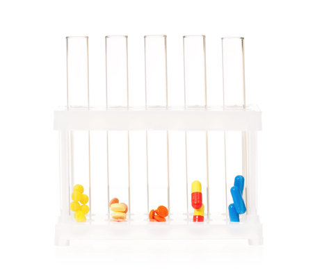 Pills and vitamins in test tubes on white background 