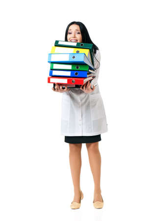Young female doctor shocked with folders, isolated on white backgroundの写真素材