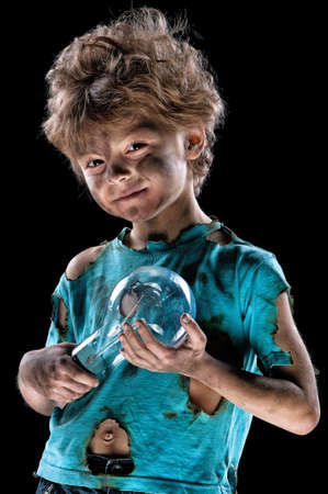 Portrait of funny little electrician over black backgroundの写真素材