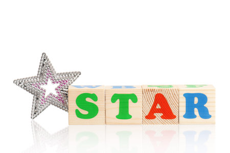 STAR word formed by wood alphabet blocks with magic wand isolated on white backgroundの写真素材