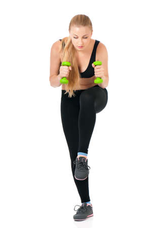 Full body of happy young woman in fitness wear exercising with dumbbells, isolated on white backgroundの写真素材