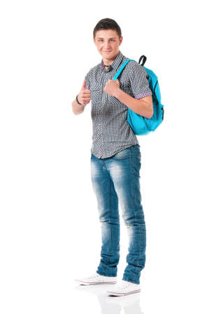 Successful young student boy showing thumb sign with backpack, isolated on white backgroundの写真素材