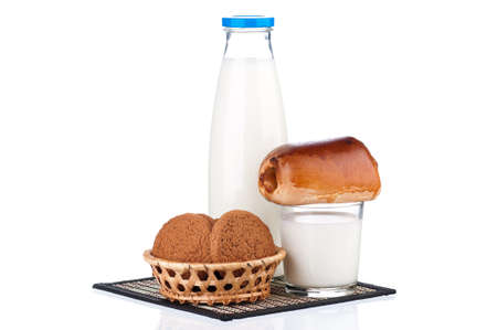 Bottle of milk, oat cookies and bun with poppy seeds, isolated on white backgroundの写真素材