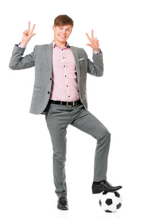 Young man in suit with soccer ball, isolated on white backgroundの写真素材