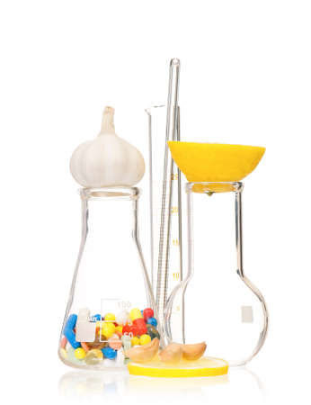 Test tubes with colorful pills slice lemon and garlic, isolated on white backgroundの写真素材