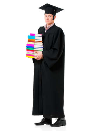 Graduate guy student in mantle with books, isolated on white backgroundの写真素材