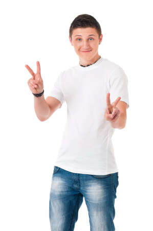 Successful young student boy showing victory sign, isolated on white backgroundの写真素材