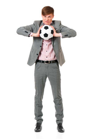Successful young businessman in suit with soccer ball, isolated on white backgroundの写真素材