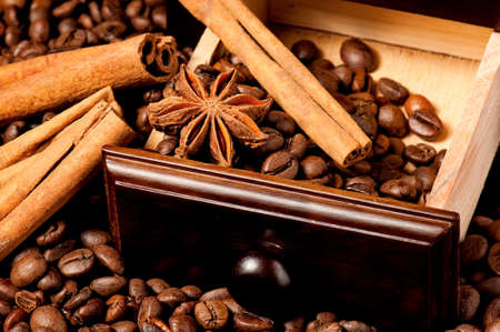 Anise stars and cinnamon on roasted coffee beansの写真素材