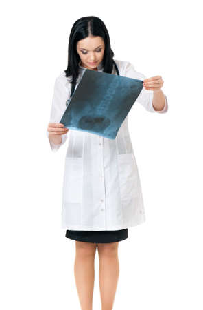Female doctor examining an x-ray picture on white backgroundの写真素材