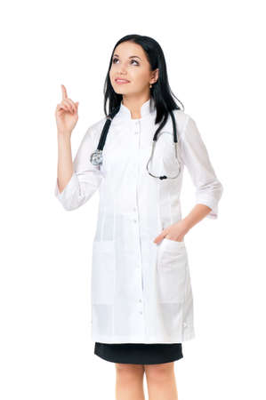 Smiling medical doctor woman with stethoscope showing something, isolated on white backgroundの写真素材