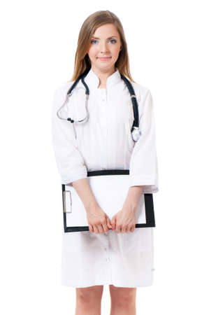 Portrait of smiling female doctor holding a clipboard - isolated over a white backgroundの写真素材