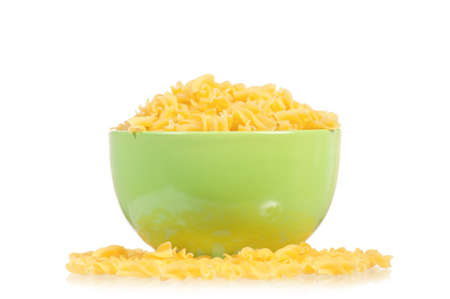 Raw pasta in bowl isolated on white backgroundの写真素材