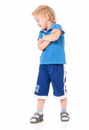 Portrait of little boy with hands folded isolated on white backgroundの写真素材