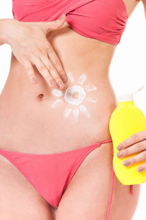 Woman with suntan lotion in form of the sun isolated on white backgroundの写真素材