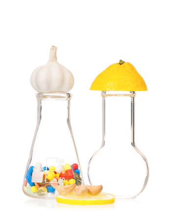 Test tubes with colorful pills slice lemon and garlic, isolated on white backgroundの写真素材