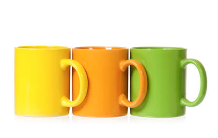 Three colorful mugs for coffee or tea, isolated on white backgroundの写真素材