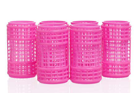 Pink hair curlers isolated on white backgroundの写真素材