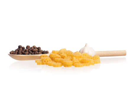 Pasta with wooden spoon and spices, isolated on white backgroundの写真素材