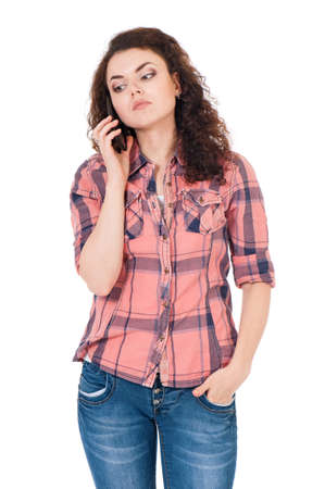 Unhappy girl with cellular telephone, isolated on white backgroundの写真素材